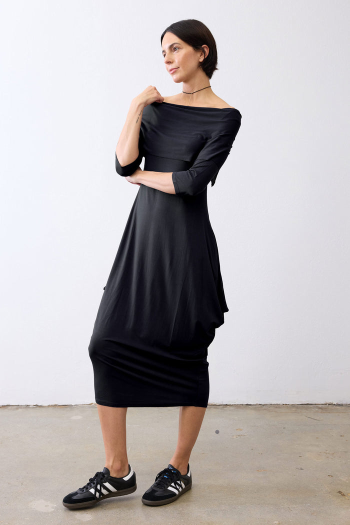 Black off-shoulder midi dress with 3/4 sleeves, fitted through hips, flowing hem.
