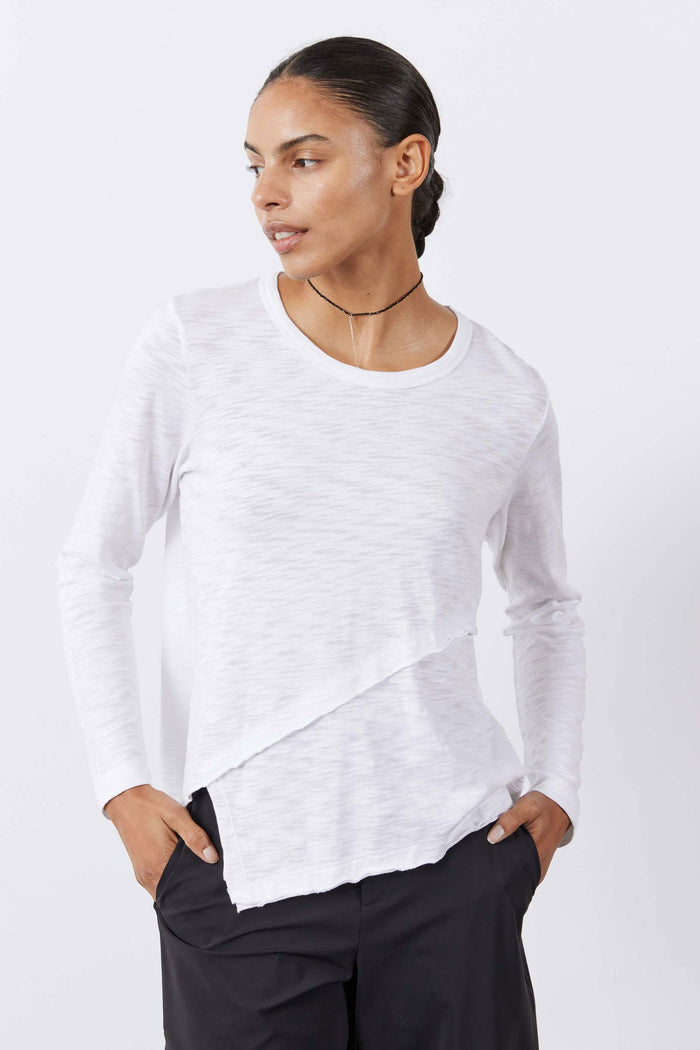 White heathered asymmetric long sleeve top with crew neck and angled side hem