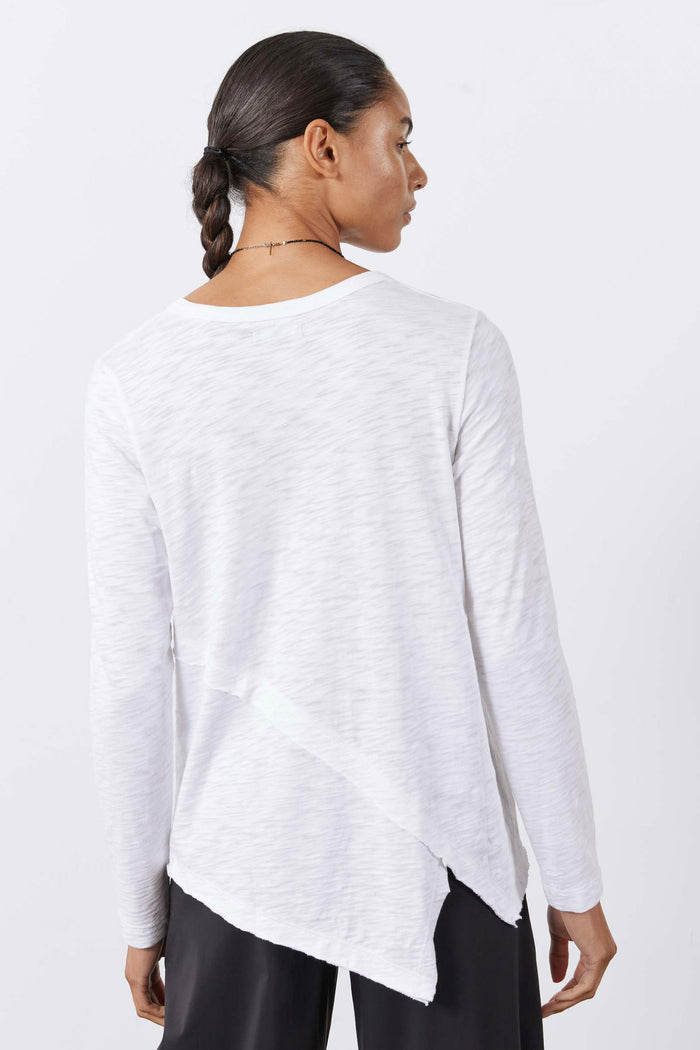 White asymmetric long sleeve top, back view with curved hem and crew neckline