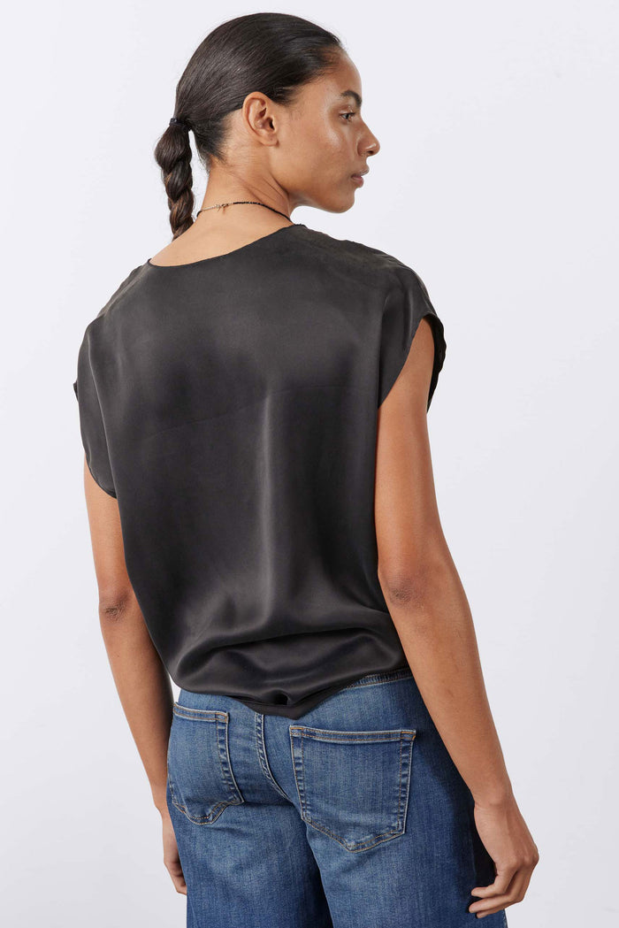 Black silk top back view with short sleeves and smooth, flowing drape