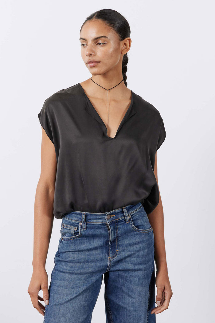Black silk V-neck top with short sleeves, relaxed fit on model