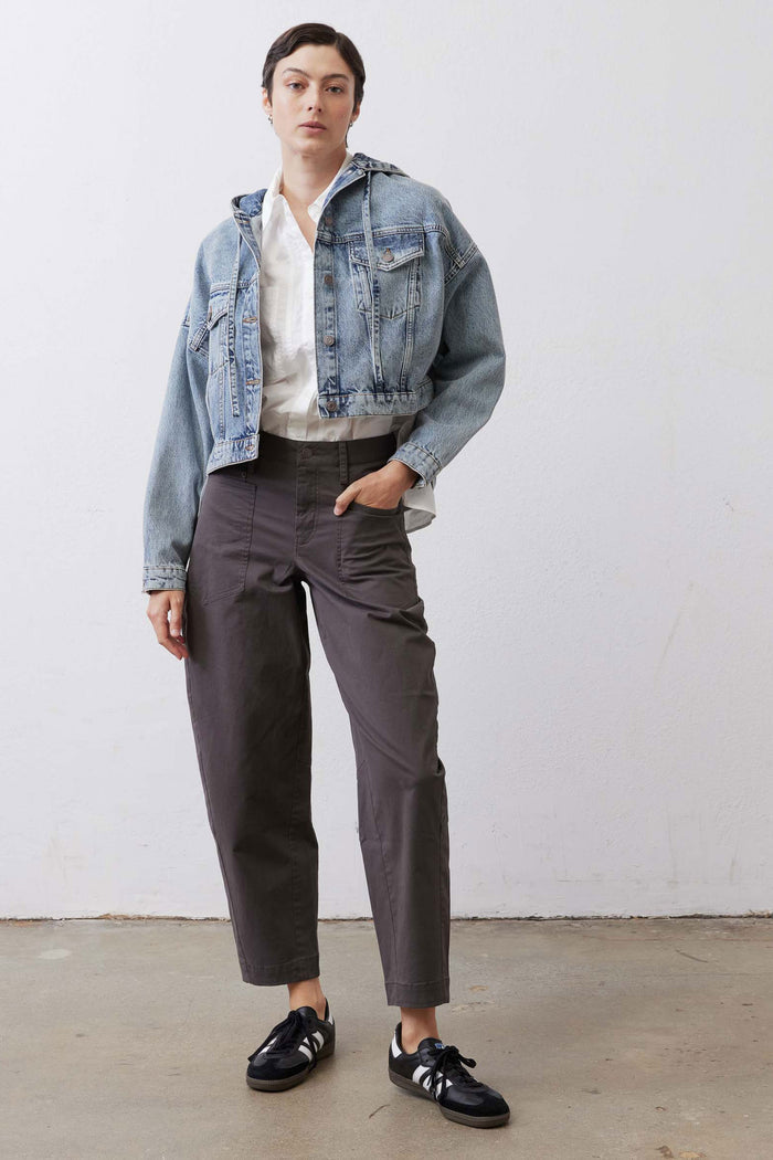 Washed blue denim jacket with pointed collar, button placket, and chest patch pockets