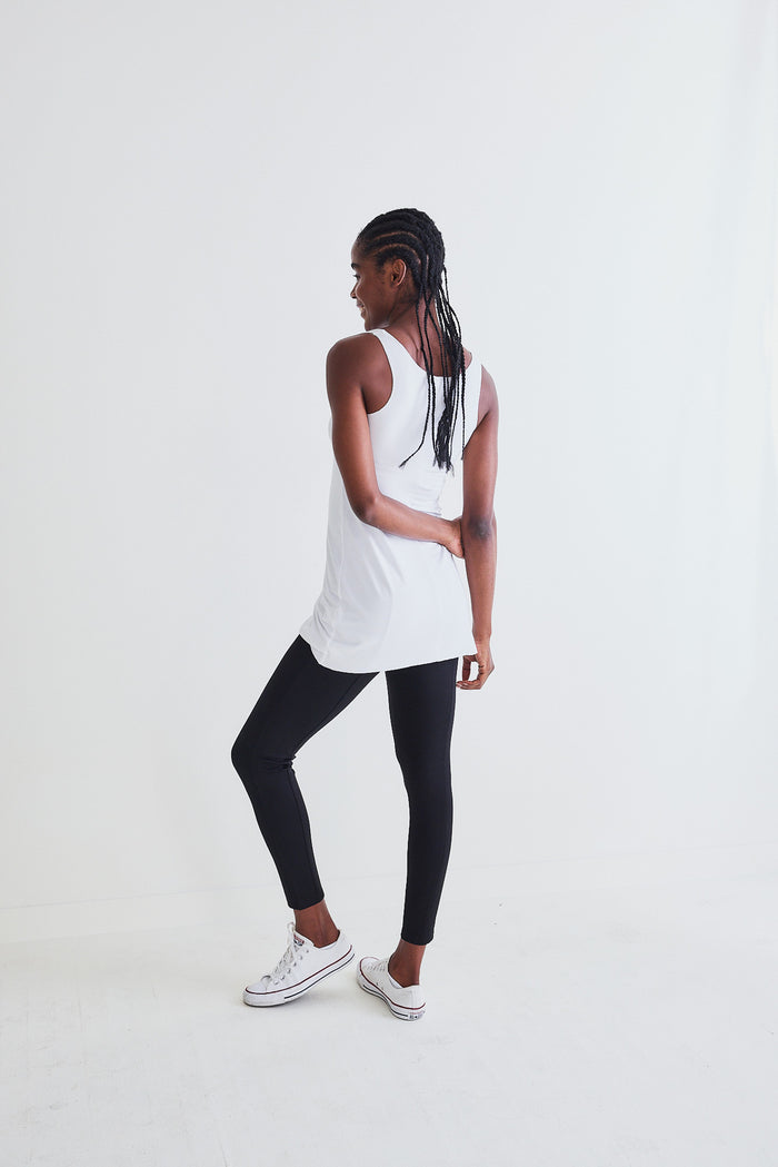 White long seamless cami worn with black leggings; racerback style