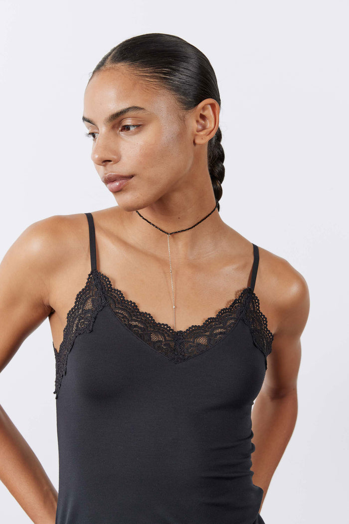 Black lace camisole close-up with lace-trim straps and neckline