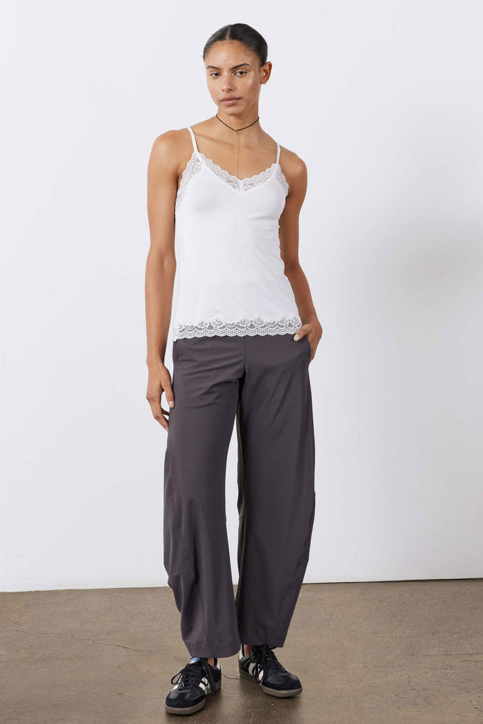 White lace-trim cami with spaghetti straps and scalloped hem