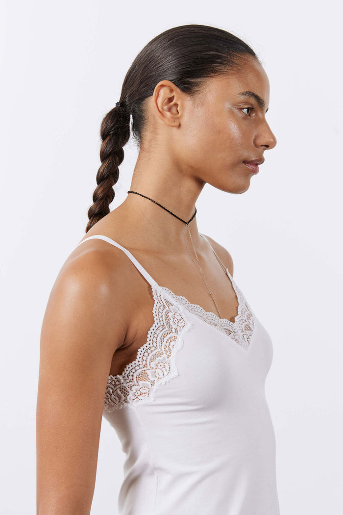 White lace-trim cami with spaghetti straps and lace back detail, side view